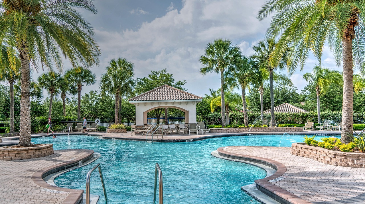 Resort pool with palm trees and a cabana