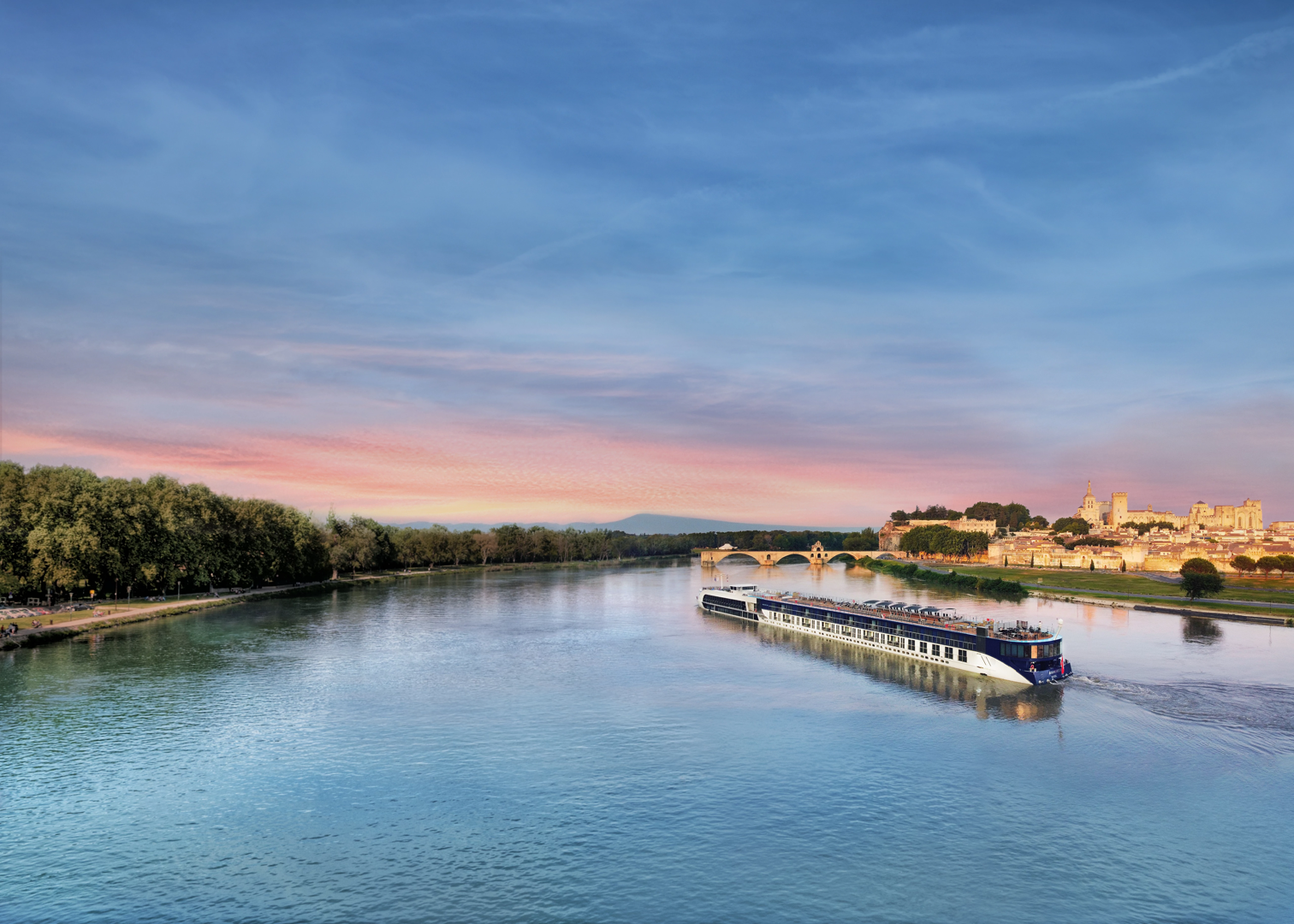 River cruise ship sailing past European castle and vineyards