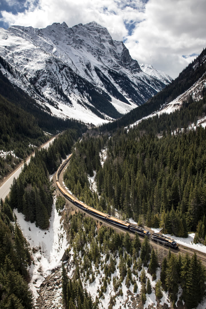 Rocky Mountaineer train crossing Stoney Creek Bridge with mountain scenery