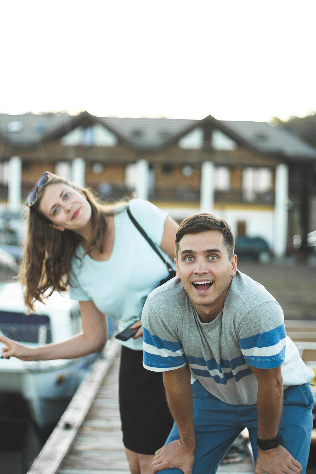 Happy couple enjoying a day at the marina, ready for their next travel adventure.