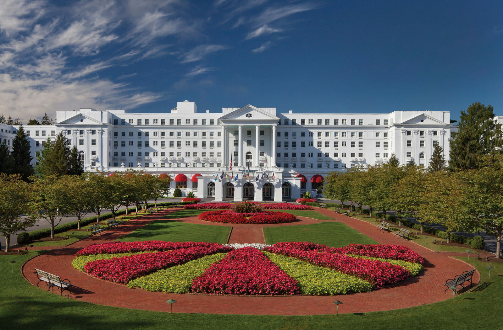 The white facade and formal gardens of The Greenbrier resort