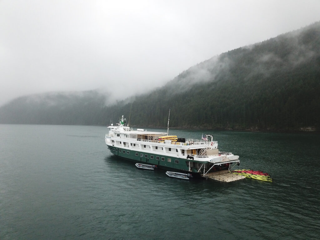 an uncruise boat sits in an alaskan fjord