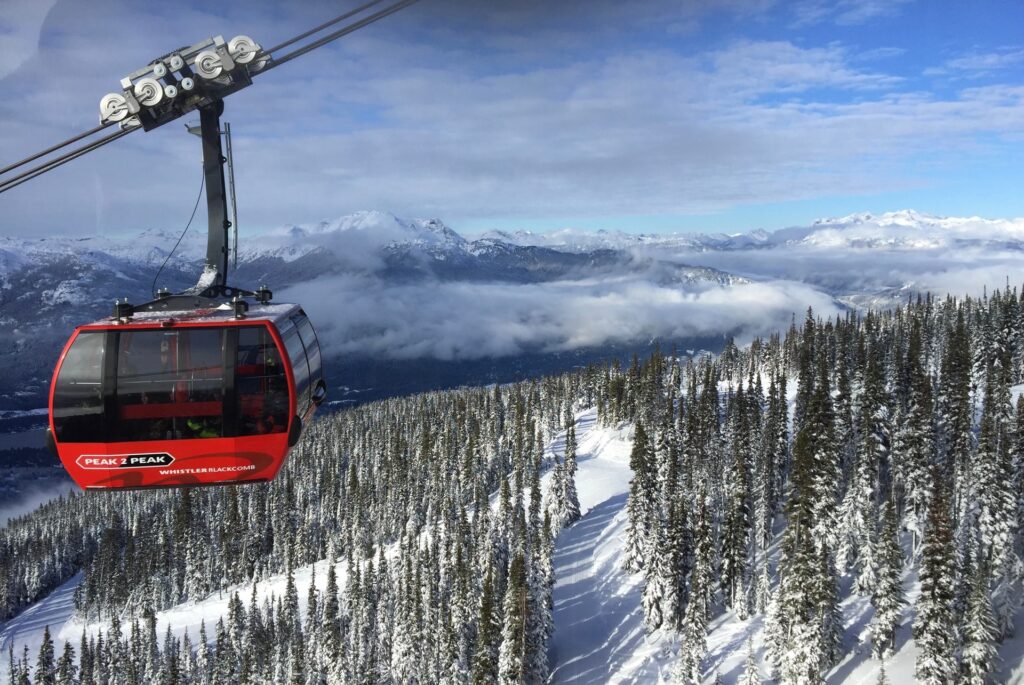 The Peak to Peak Gondola in Whistler Blackcomb mid-route with a snowy mountain below