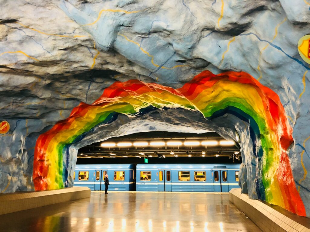 the rainbow-color painted entrance to a metro station in stockholm, sweden