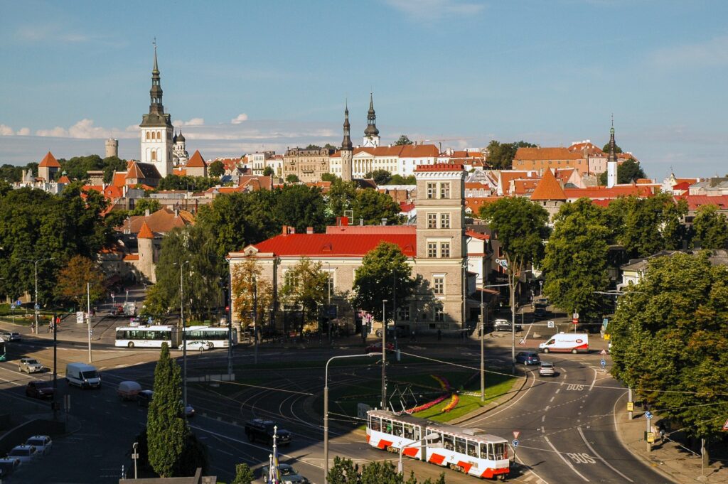 an aerial view of a large intersection in Tallinn with the old town in the background