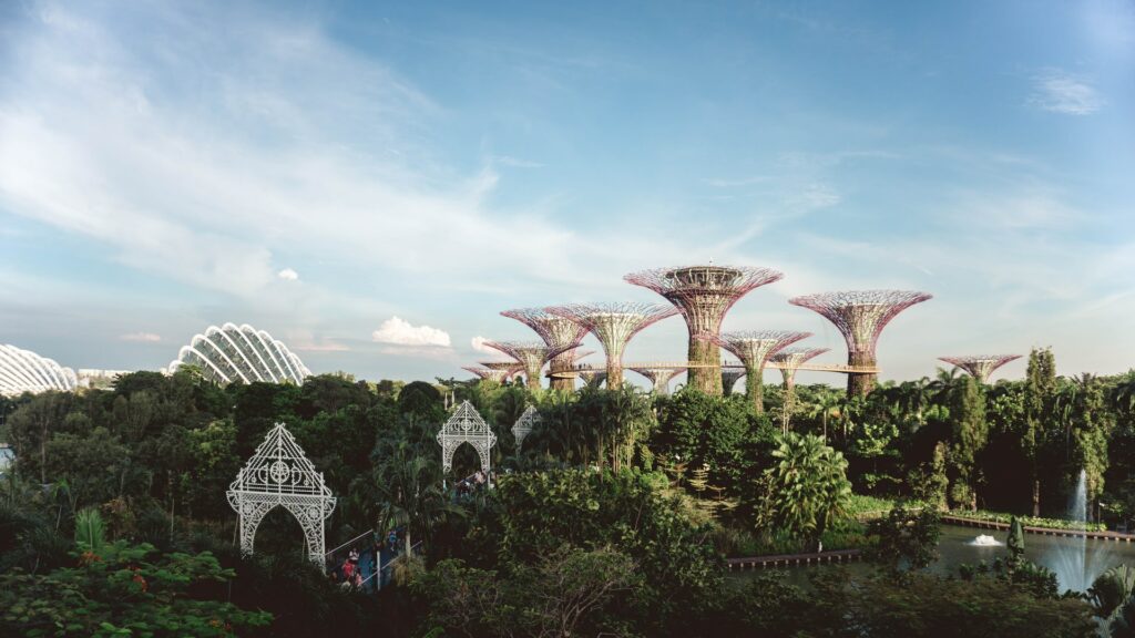 a view of Singapore shows garden with large art sculptures travel agent