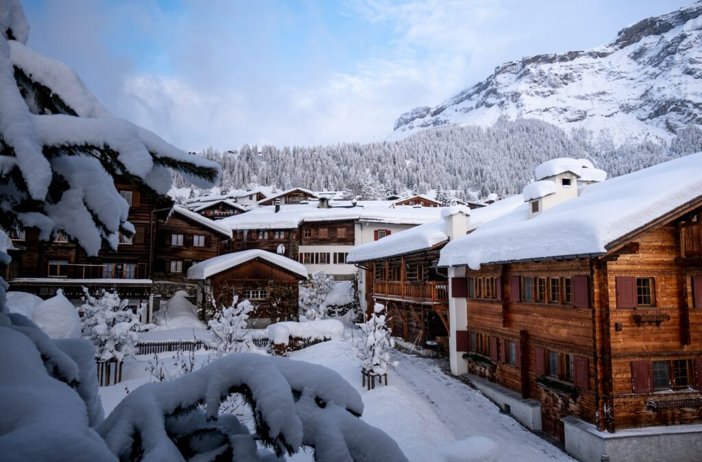 winter scene in Switzerland shows a snowy scene with multiple chalets