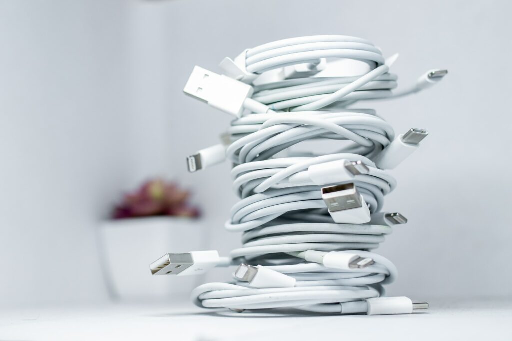 a stack of cables sitting on a table to indicate the best travel gear we're packing in 2022